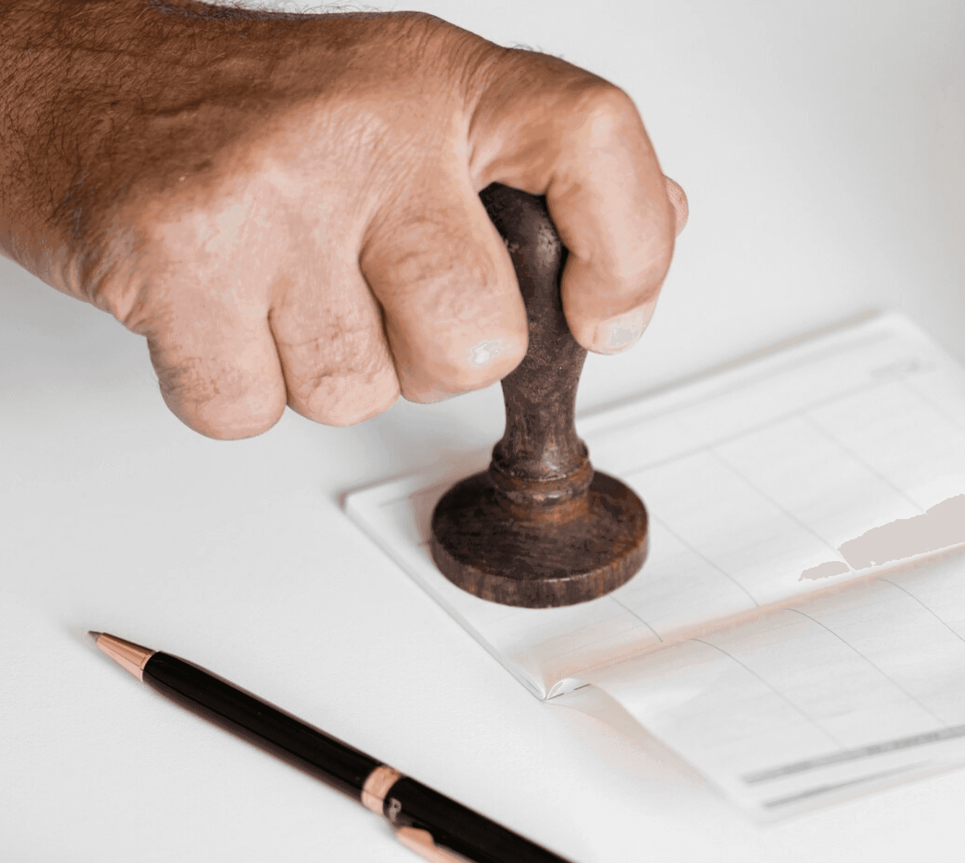 Hand stamping legal approval document, representing licence approval process through Barnab.