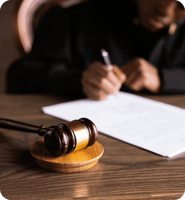 Legal professional signing documents next to a judge’s gavel during a licence approval.